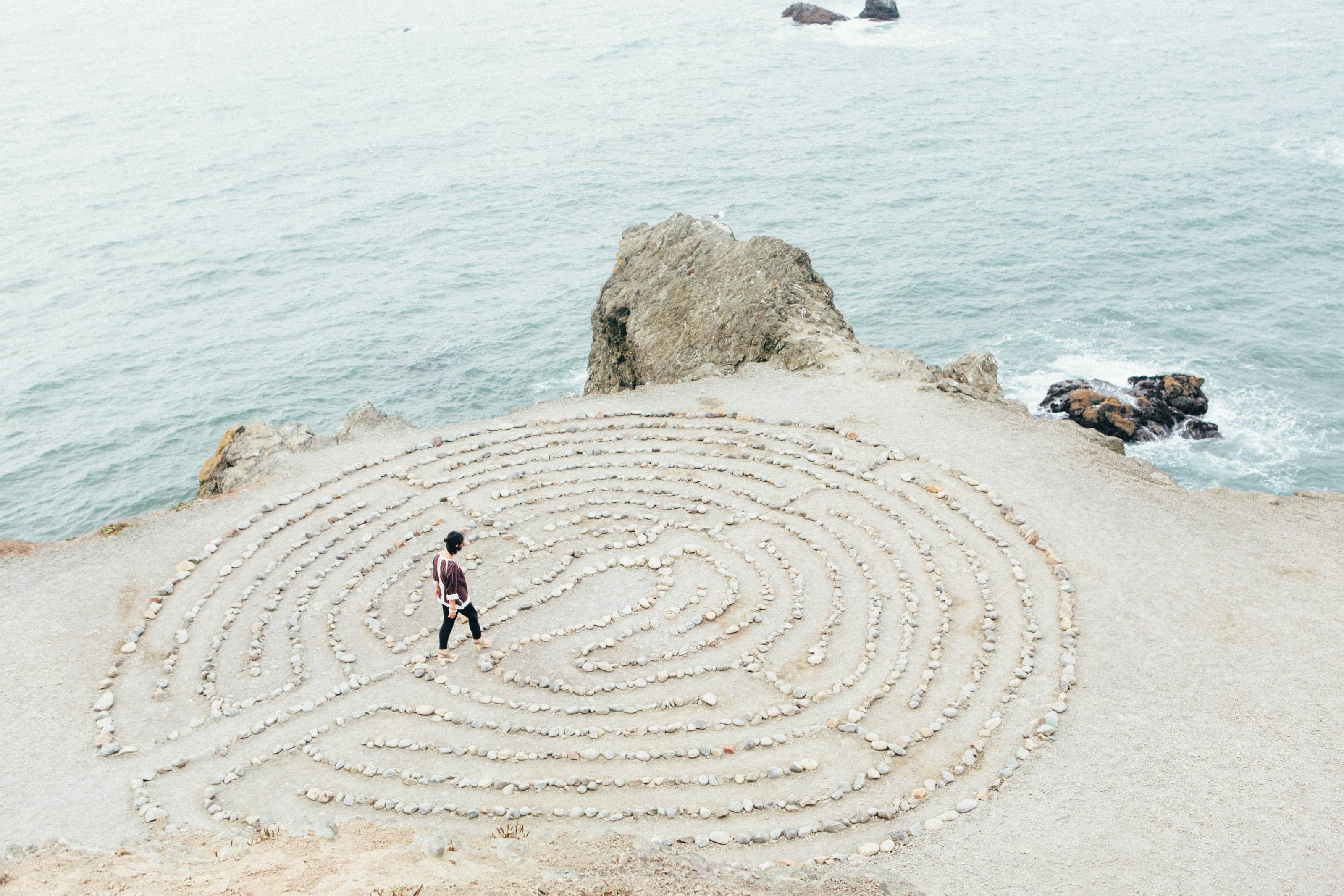 A stone labyrinth by the sea, representing a considered path to care